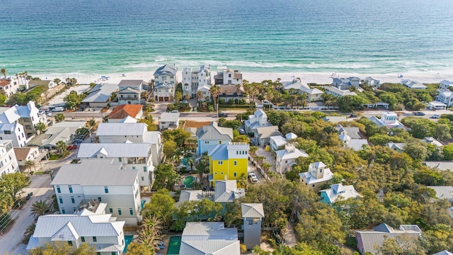 birds eye view of property with a beach view, a water view, and a residential view