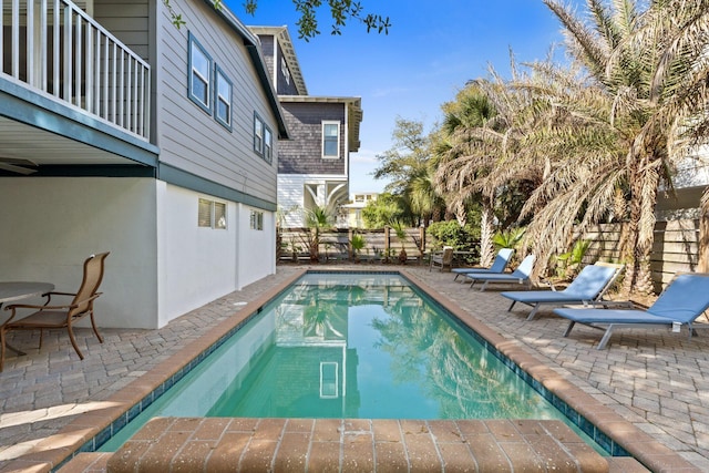 view of swimming pool featuring a fenced backyard, a fenced in pool, and a patio area