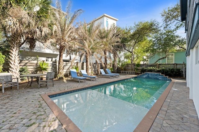 view of swimming pool with a patio, central AC, a fenced backyard, and a fenced in pool