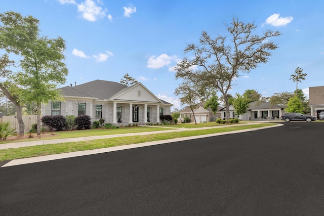 view of front facade with fence and a front yard