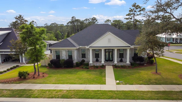 neoclassical home with a porch, roof with shingles, and a front yard