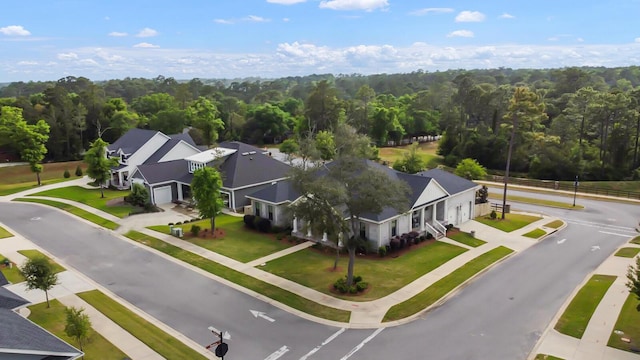 drone / aerial view with a wooded view