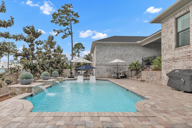 view of pool featuring fence, stairs, area for grilling, a fenced in pool, and a patio area