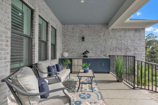view of patio / terrace featuring a sink, an outdoor living space, and a balcony