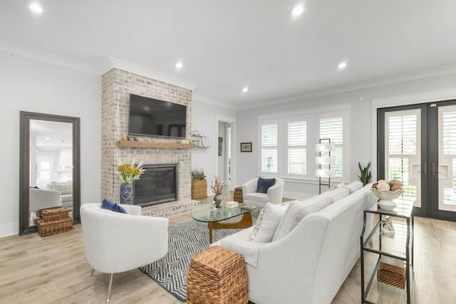 living room featuring french doors, ornamental molding, light wood-style flooring, and recessed lighting