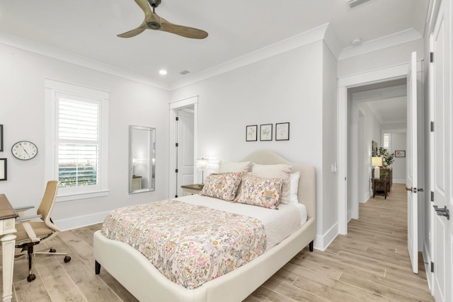 bedroom with crown molding, baseboards, and light wood-style flooring