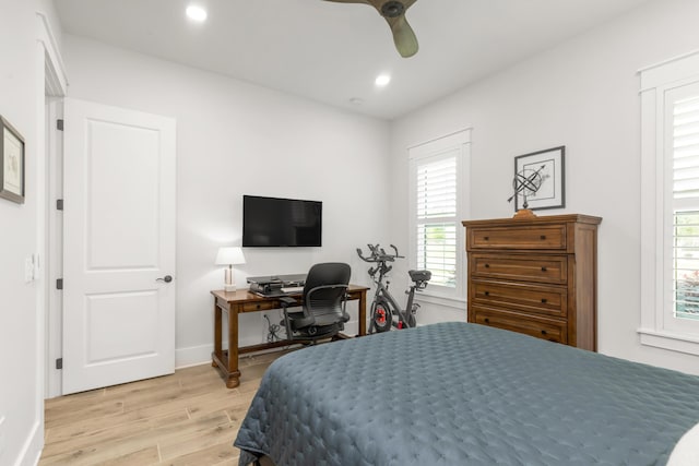 bedroom featuring recessed lighting, baseboards, multiple windows, and light wood-style floors
