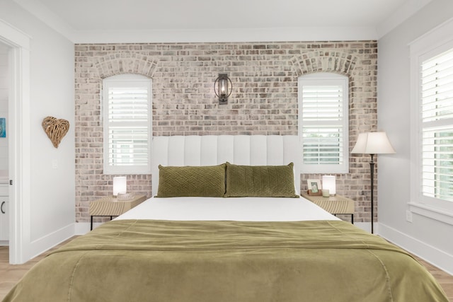 bedroom featuring baseboards and wood finished floors