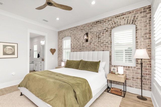 bedroom with baseboards, visible vents, wood finished floors, and brick wall