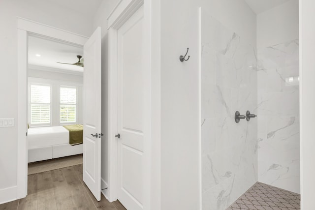 ensuite bathroom featuring a marble finish shower, ornamental molding, ensuite bathroom, and wood finished floors