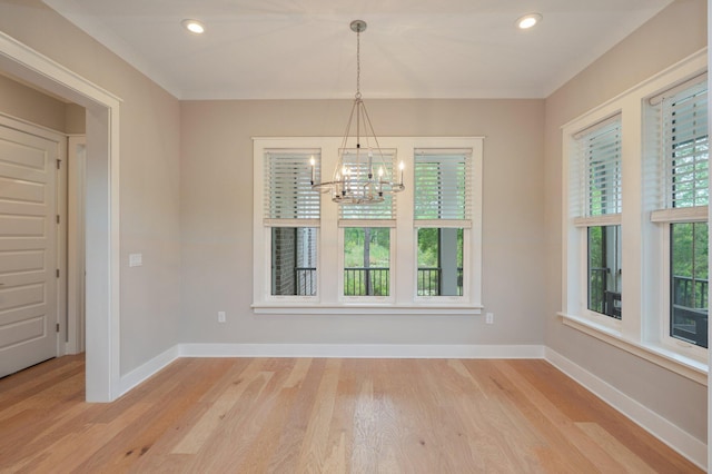 unfurnished dining area with recessed lighting, baseboards, a notable chandelier, and light wood-type flooring