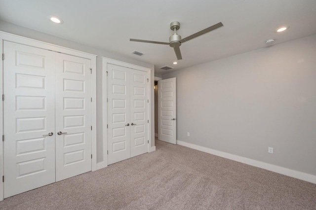 unfurnished bedroom featuring visible vents, baseboards, recessed lighting, a ceiling fan, and carpet