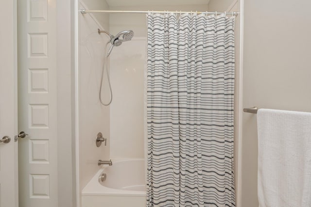 bathroom with shower / tub combo with curtain