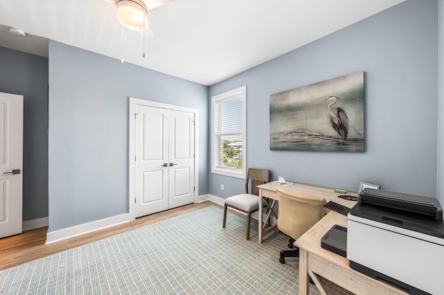 home office featuring wood finished floors and baseboards