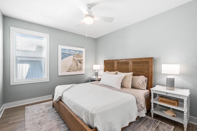 bedroom with wood finished floors, baseboards, and a ceiling fan
