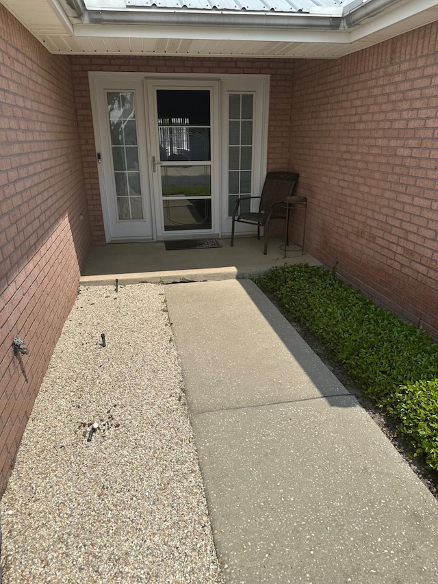 entrance to property with brick siding