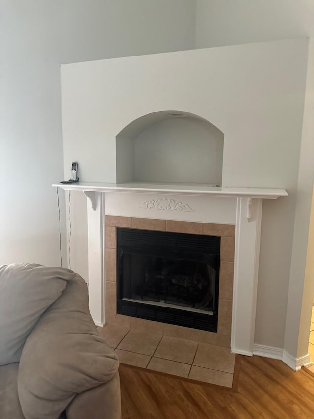 interior details with baseboards, wood finished floors, and a fireplace