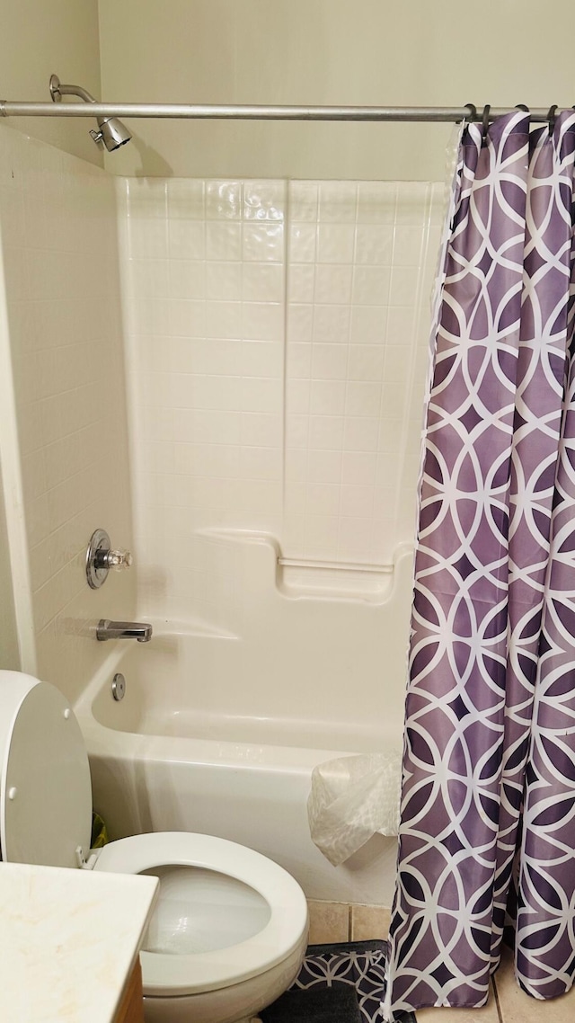 bathroom featuring toilet, shower / bath combo with shower curtain, and vanity
