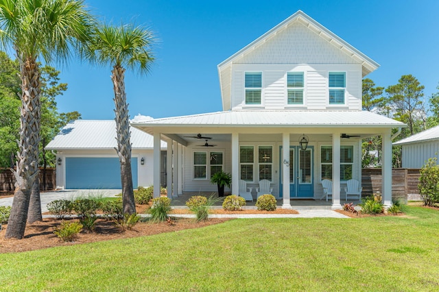 65 Horseshoe Cir, Miramar Beach, FL 32550 - farmhouse featuring a garage, ceiling fan, fence, covered porch, and a front yard
