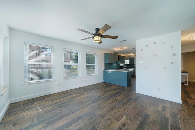 kitchen with dark wood-style floors, ceiling fan, a peninsula, baseboards, and open floor plan