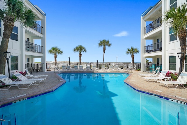 community pool featuring a patio and fence