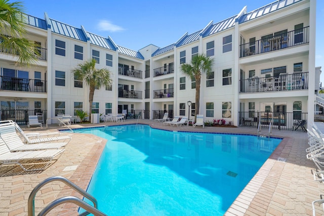community pool with a patio area