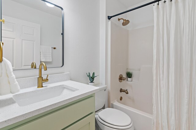bathroom featuring vanity, shower / tub combo with curtain, and toilet