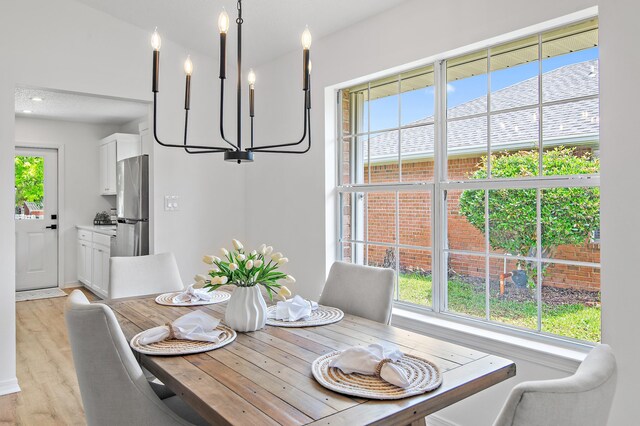 dining room with plenty of natural light and light wood finished floors