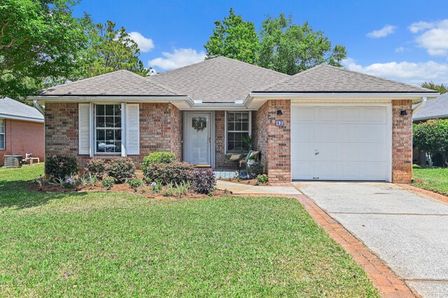 ranch-style home featuring brick siding, driveway, a front lawn, and a garage