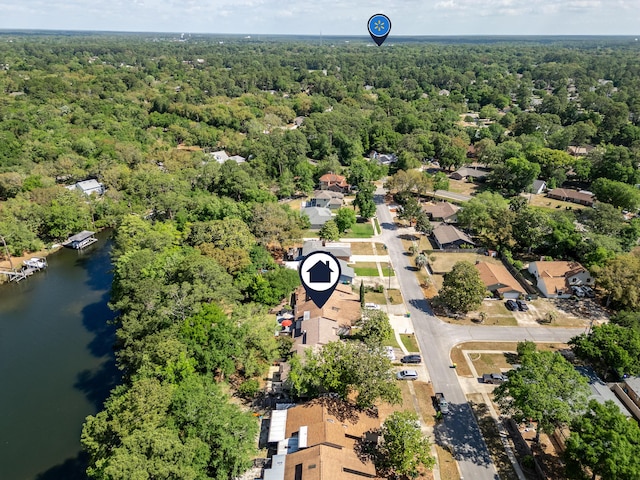 aerial view featuring a wooded view and a water view