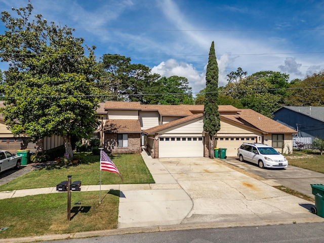traditional-style home featuring a front lawn, driveway, brick siding, and a garage