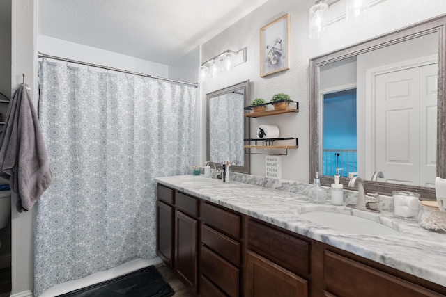 full bath featuring double vanity and a sink