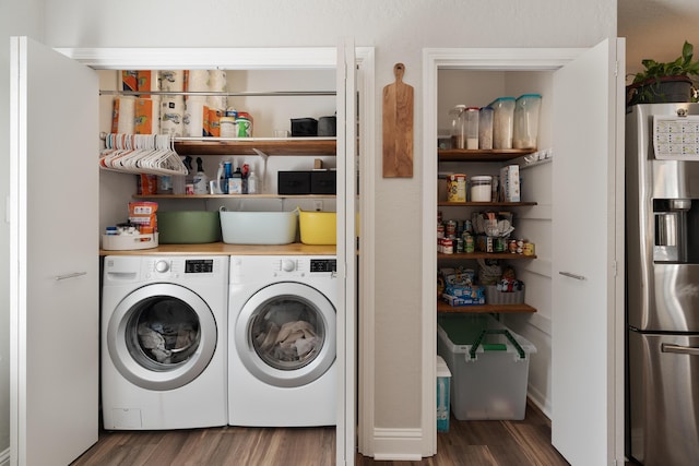 clothes washing area featuring separate washer and dryer, laundry area, and wood finished floors