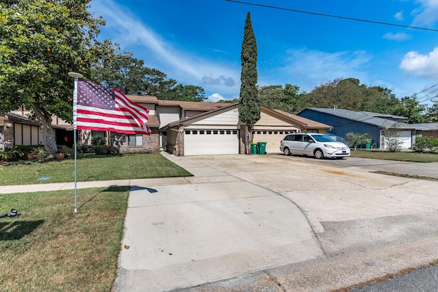 view of front of house with a front lawn, brick siding, driveway, and a garage