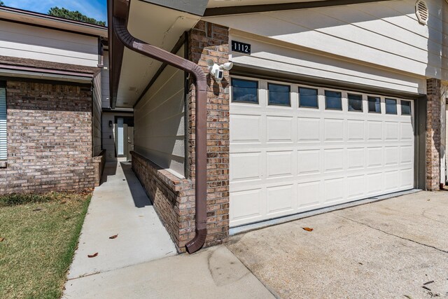 garage featuring concrete driveway