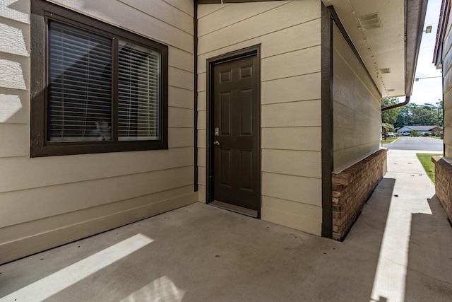entrance to property with a patio
