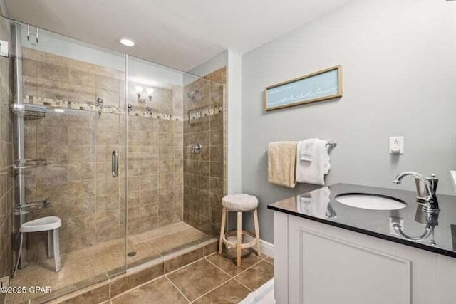 16701 Front Beach Rd Unit 2307, Panama City Beach, FL 32413 - bathroom with baseboards, a shower stall, tile patterned flooring, and vanity