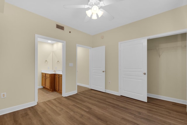 113 SE Brooks St Unit 201, Fort Walton Beach, FL 32548 - unfurnished bedroom featuring a sink, baseboards, wood finished floors, visible vents, and a closet