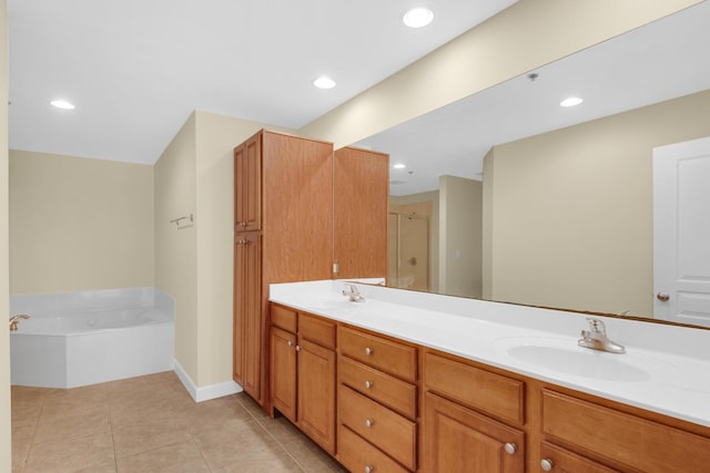 113 SE Brooks St Unit 201, Fort Walton Beach, FL 32548 - full bath featuring a garden tub, double vanity, tile patterned flooring, a shower stall, and a sink