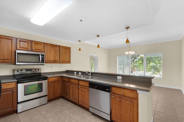 113 SE Brooks St Unit 201, Fort Walton Beach, FL 32548 - kitchen with dark countertops, appliances with stainless steel finishes, a sink, a peninsula, and light tile patterned floors