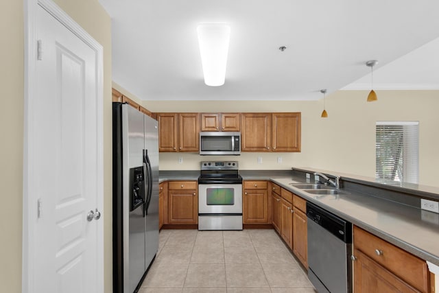 113 SE Brooks St Unit 201, Fort Walton Beach, FL 32548 - kitchen with a sink, appliances with stainless steel finishes, light tile patterned floors, and brown cabinets