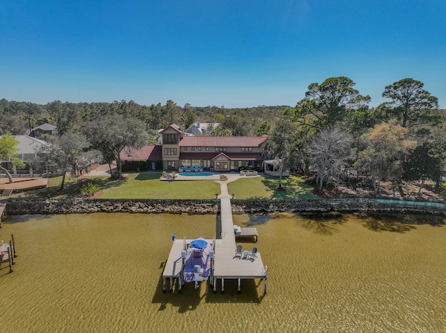 dock area with a yard, a water view, and boat lift