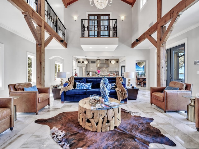 living area featuring high vaulted ceiling, an inviting chandelier, plenty of natural light, and marble finish floor