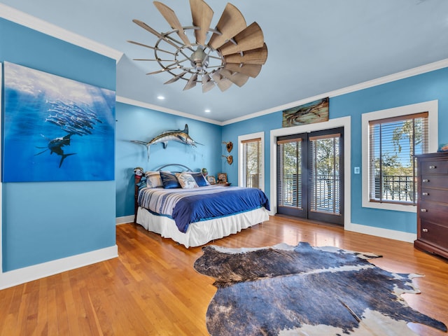 bedroom with crown molding, french doors, access to exterior, baseboards, and wood finished floors