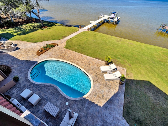 pool featuring a boat dock, a water view, boat lift, and a patio area