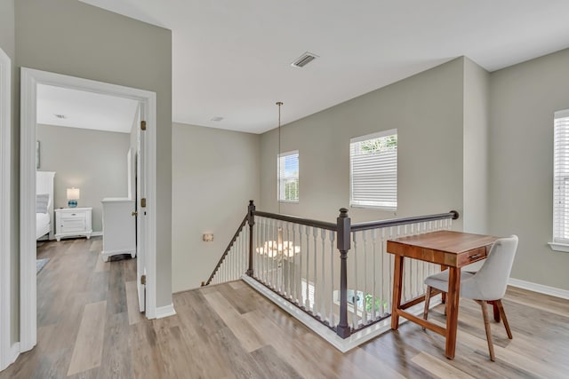 597 Avalon Blvd, Miramar Beach, FL 32550 - hall featuring baseboards, an upstairs landing, wood finished floors, and visible vents