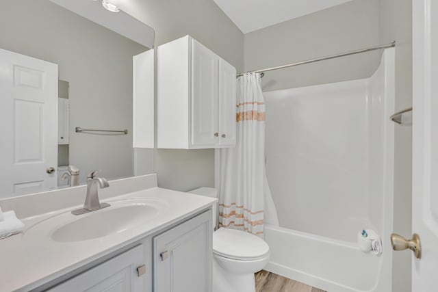 597 Avalon Blvd, Miramar Beach, FL 32550 - bathroom with vanity, shower / bathtub combination with curtain, wood finished floors, and toilet