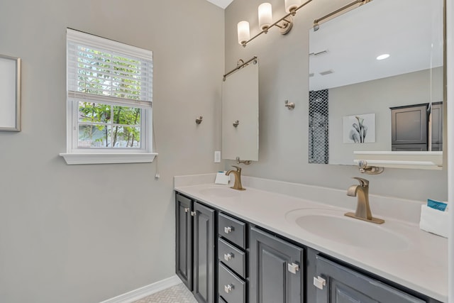 597 Avalon Blvd, Miramar Beach, FL 32550 - bathroom with double vanity, a sink, and baseboards
