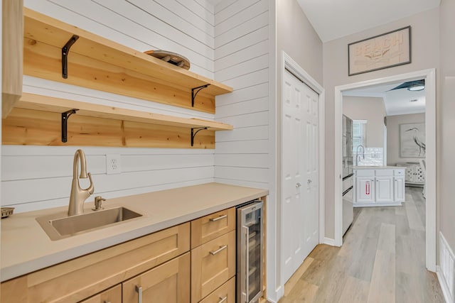 597 Avalon Blvd, Miramar Beach, FL 32550 - bar featuring beverage cooler, a sink, light wood-style flooring, and wooden walls