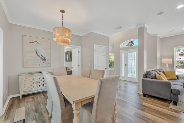 597 Avalon Blvd, Miramar Beach, FL 32550 - dining space with visible vents, wood finished floors, baseboards, a chandelier, and ornamental molding